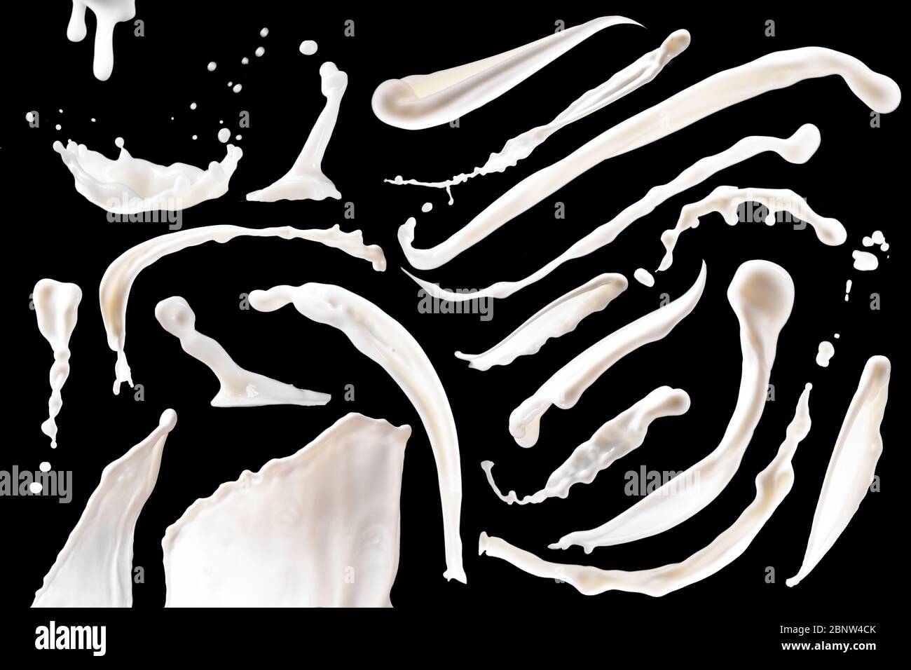 isolated white milk splashes on black background Stock Photo
