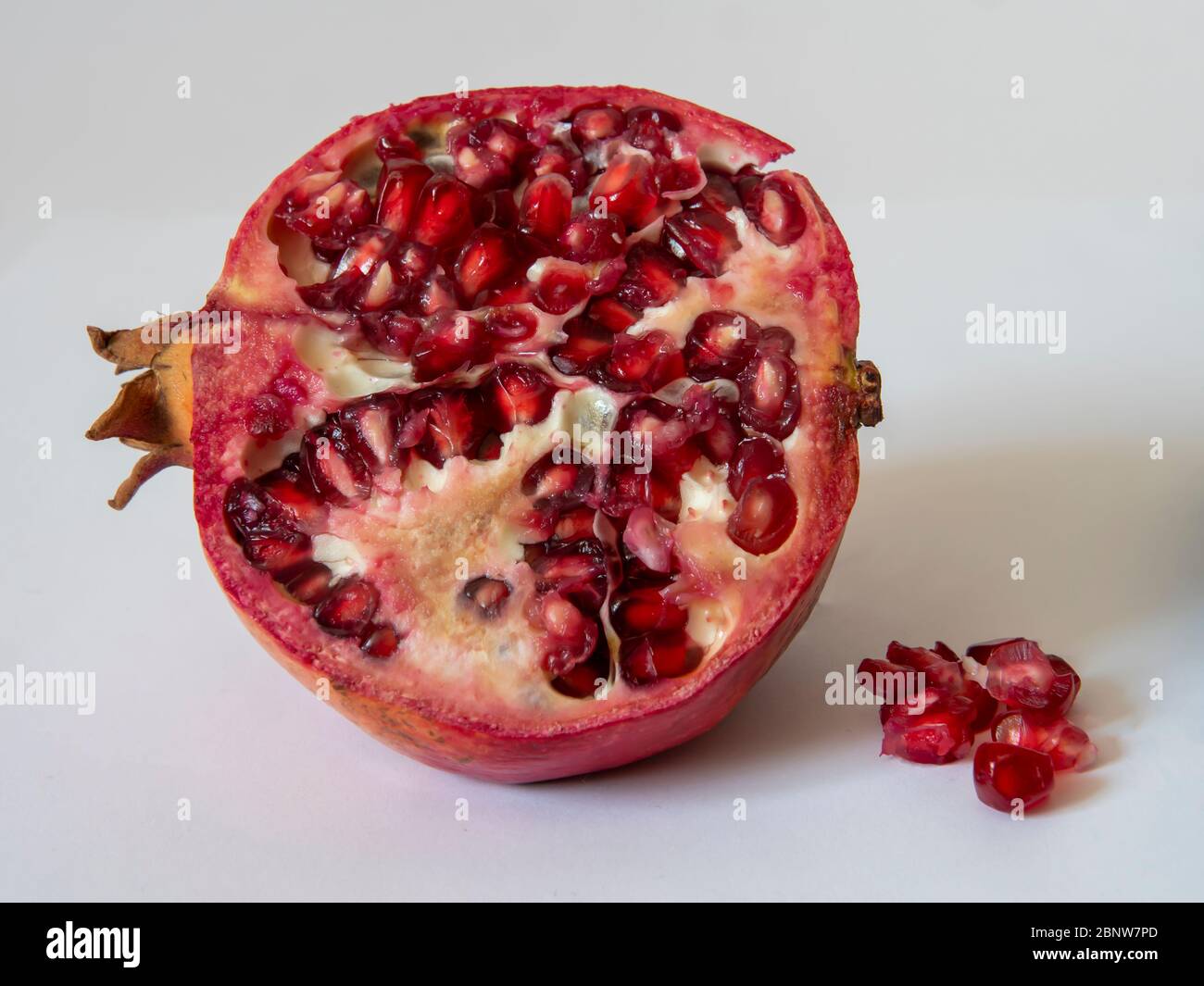 fresh pomegranate with seeds on white background Stock Photo