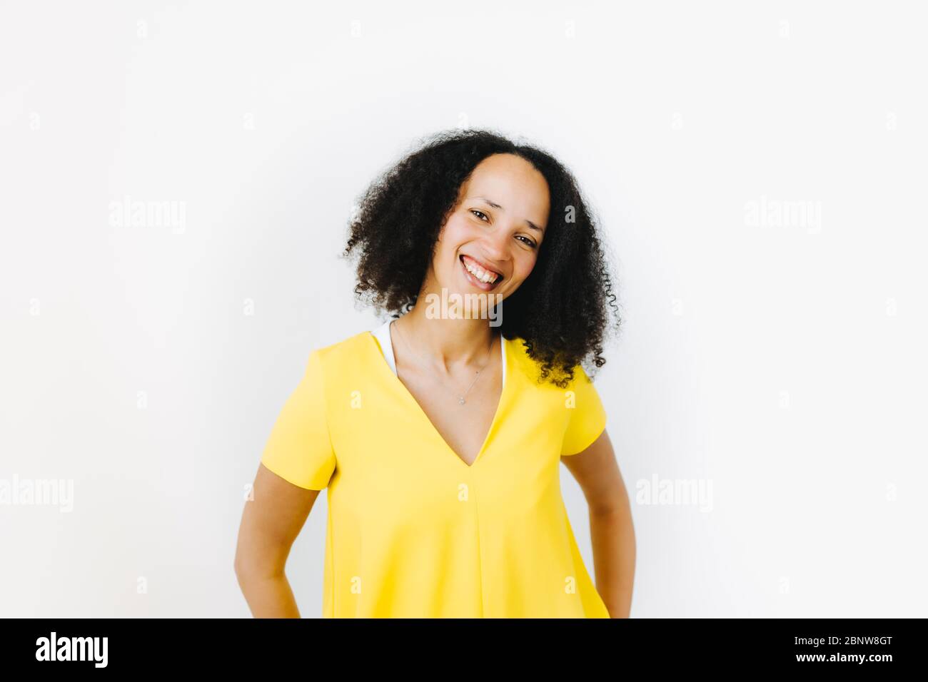 Portrait of cheerful black woman in yellow shirt Stock Photo - Alamy