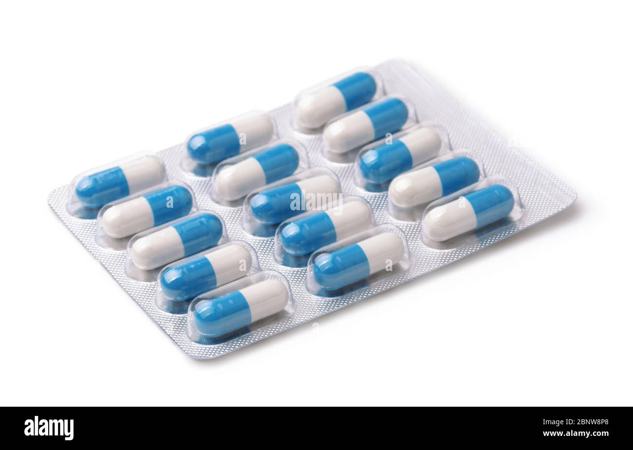 White and blue capsules in blister pack isolated on white Stock Photo
