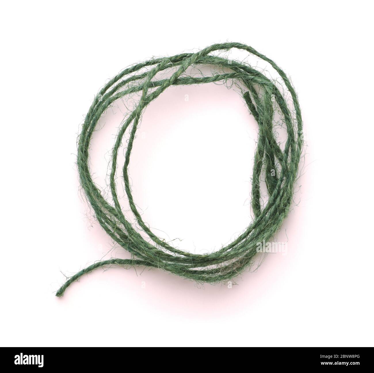 Roll of natural green twine isolated on white Stock Photo