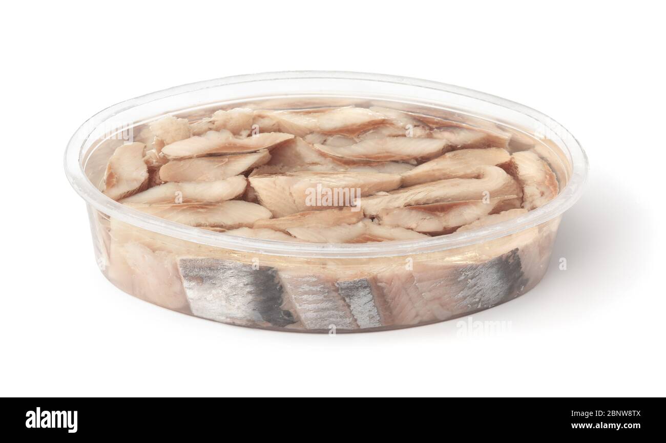 Slices of pickled atlantic herring fillet in plastic container isolated on white Stock Photo