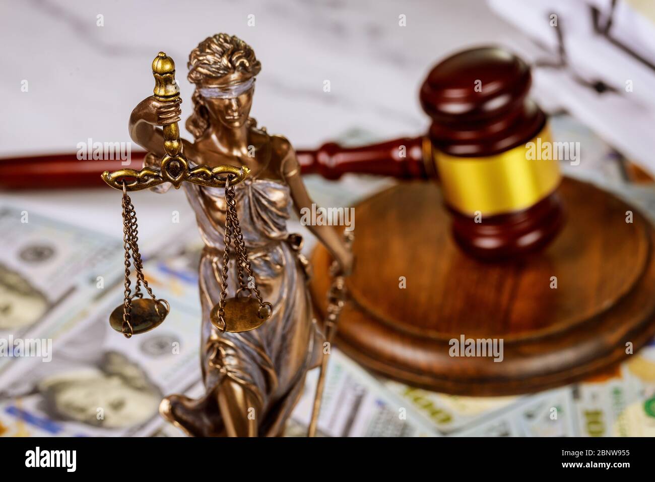 Judge's gavel with books and statue of Justice scales on law office working law document Stock