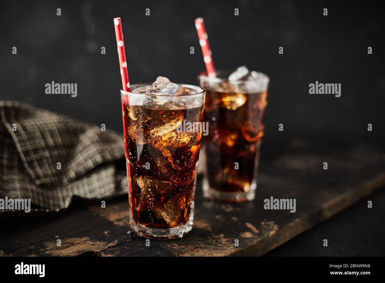 Close up glass of refreshing cola with ice on table Stock Photo - Alamy
