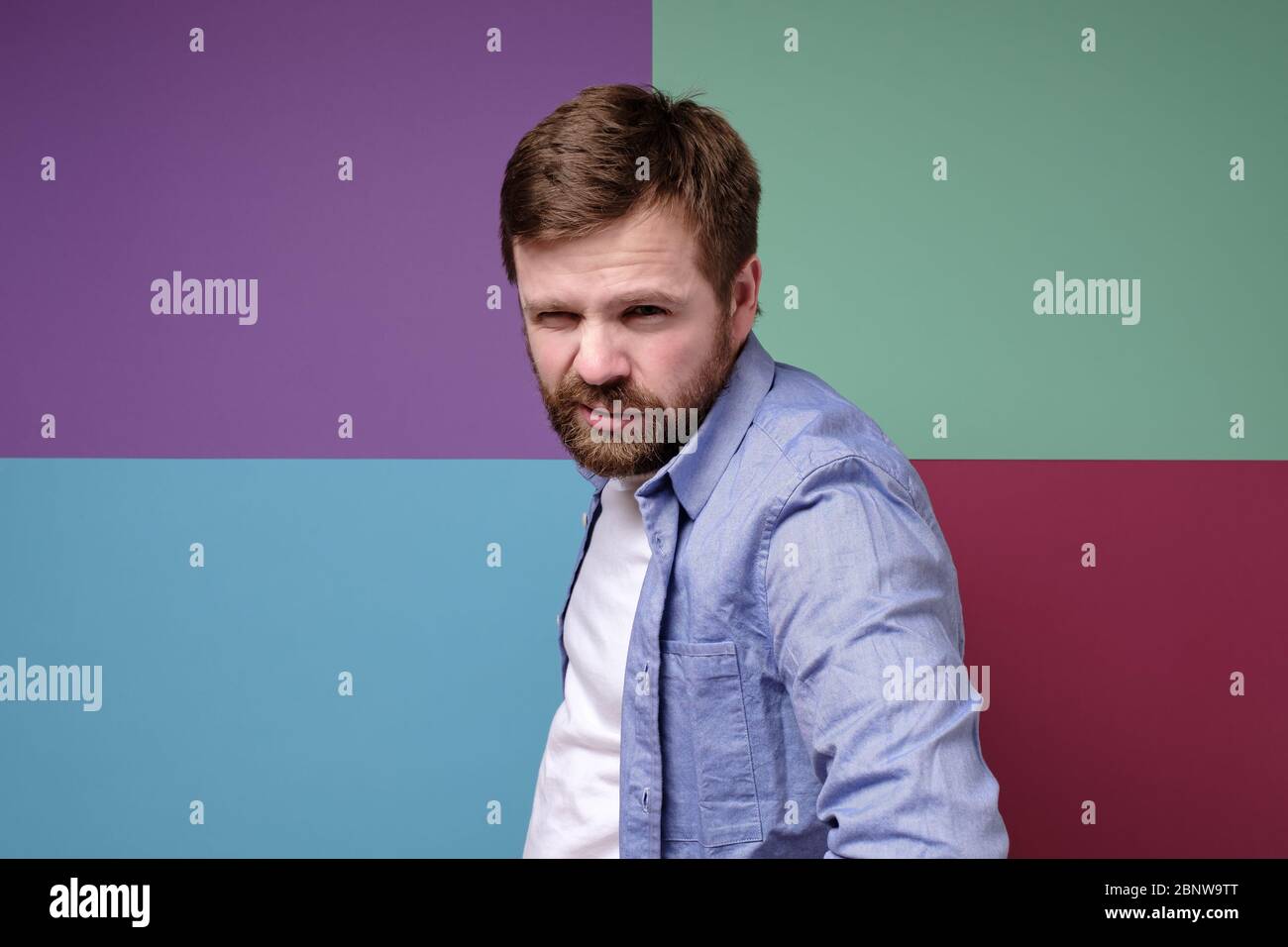 Angry, dangerous bearded man with a impudent squint. Stock Photo