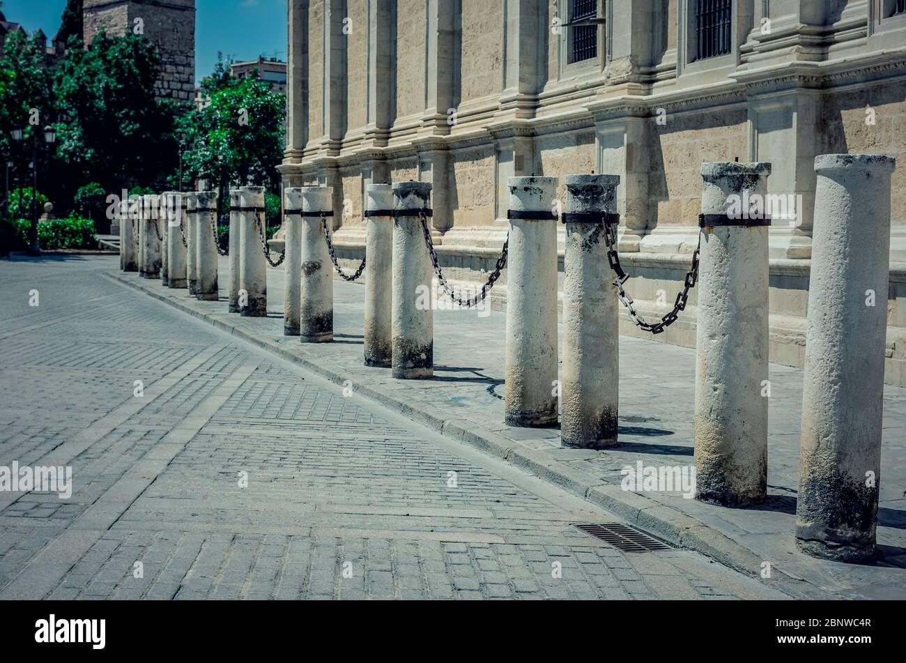 Columns and chains around the Cathedral of Seville, Andalusia, Spain during coronavirus pandemic. Empty city. No tourism. Stock Photo
