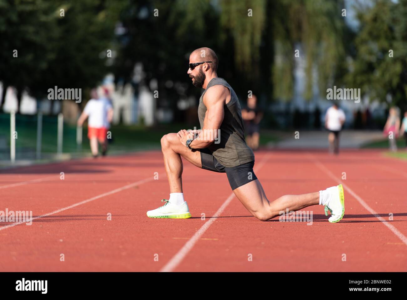 Portrait of Fit and Sporty Young Man Doing Stretching in the Park Stock ...
