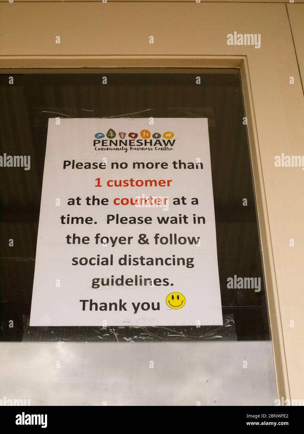 Notice on a window advising people to maintain social distancing during the Coronavirus epidemic. Stock Photo