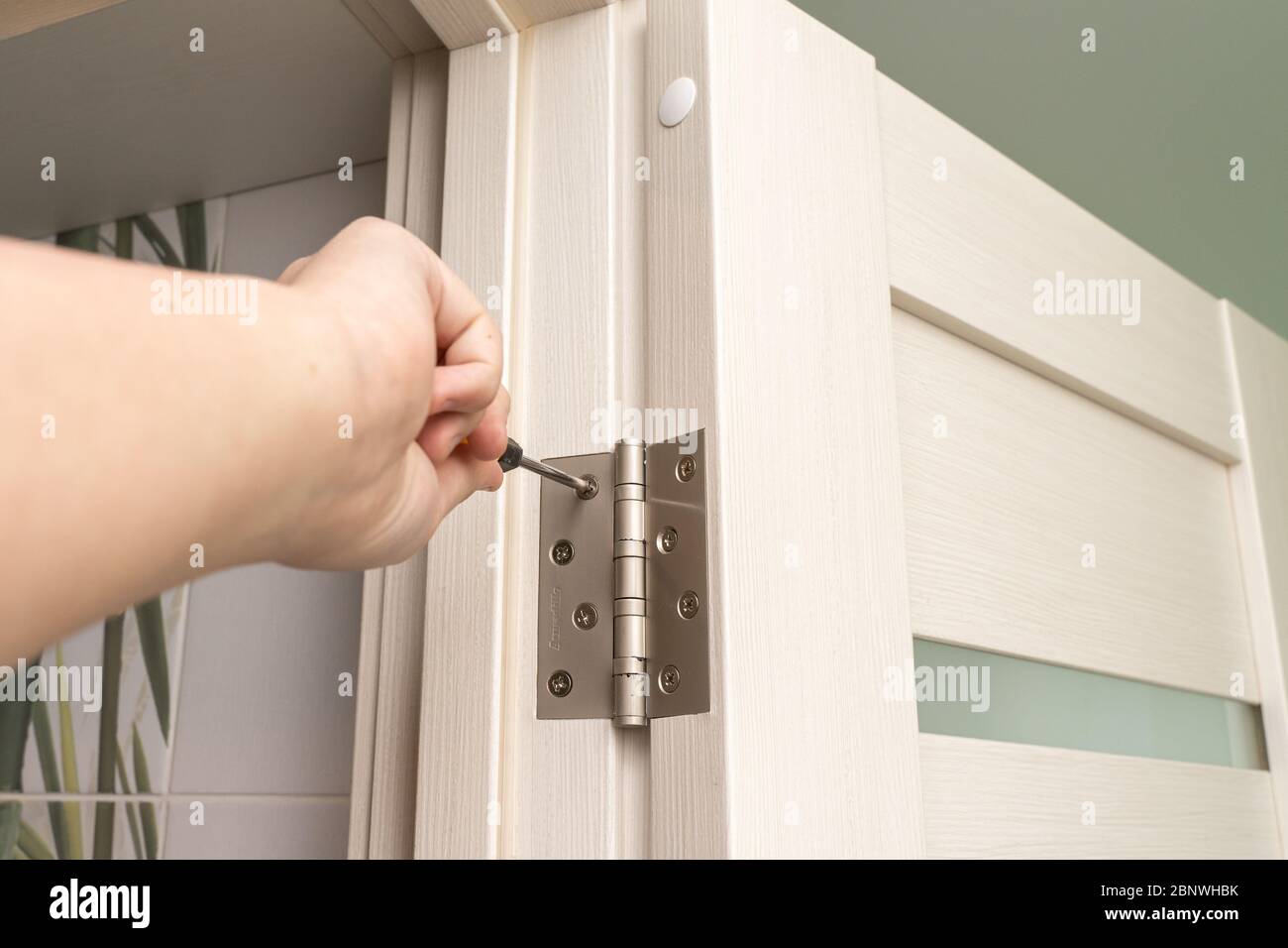 door frame installation. the master installs the door and screw the