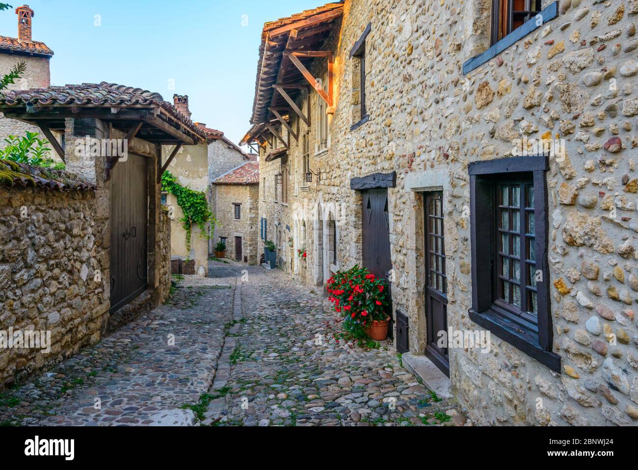 A narrow cobbled street Pérouges, a medieval walled town 30 km ...