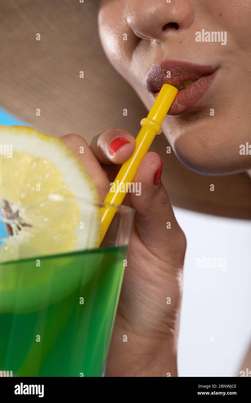 https://c8.alamy.com/comp/2BNWJCE/on-the-close-up-you-can-see-a-straw-in-the-mouth-which-is-drunk-by-a-woman-2BNWJCE.jpg