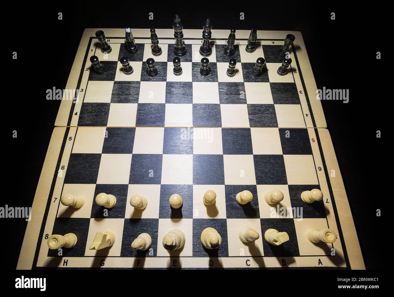 Chessboard with the pieces in the starting position seen from above Stock Photo