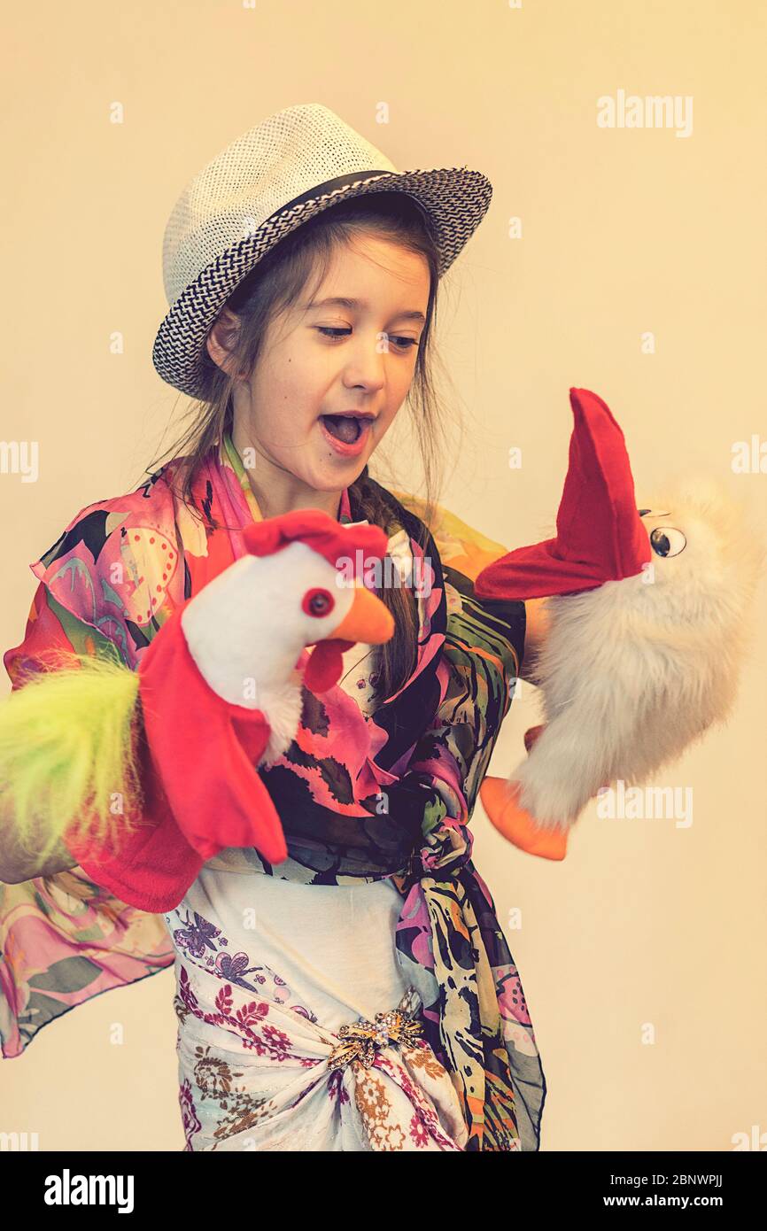 Happy child, creative fun concept - girl playing in the theater. toned Stock Photo