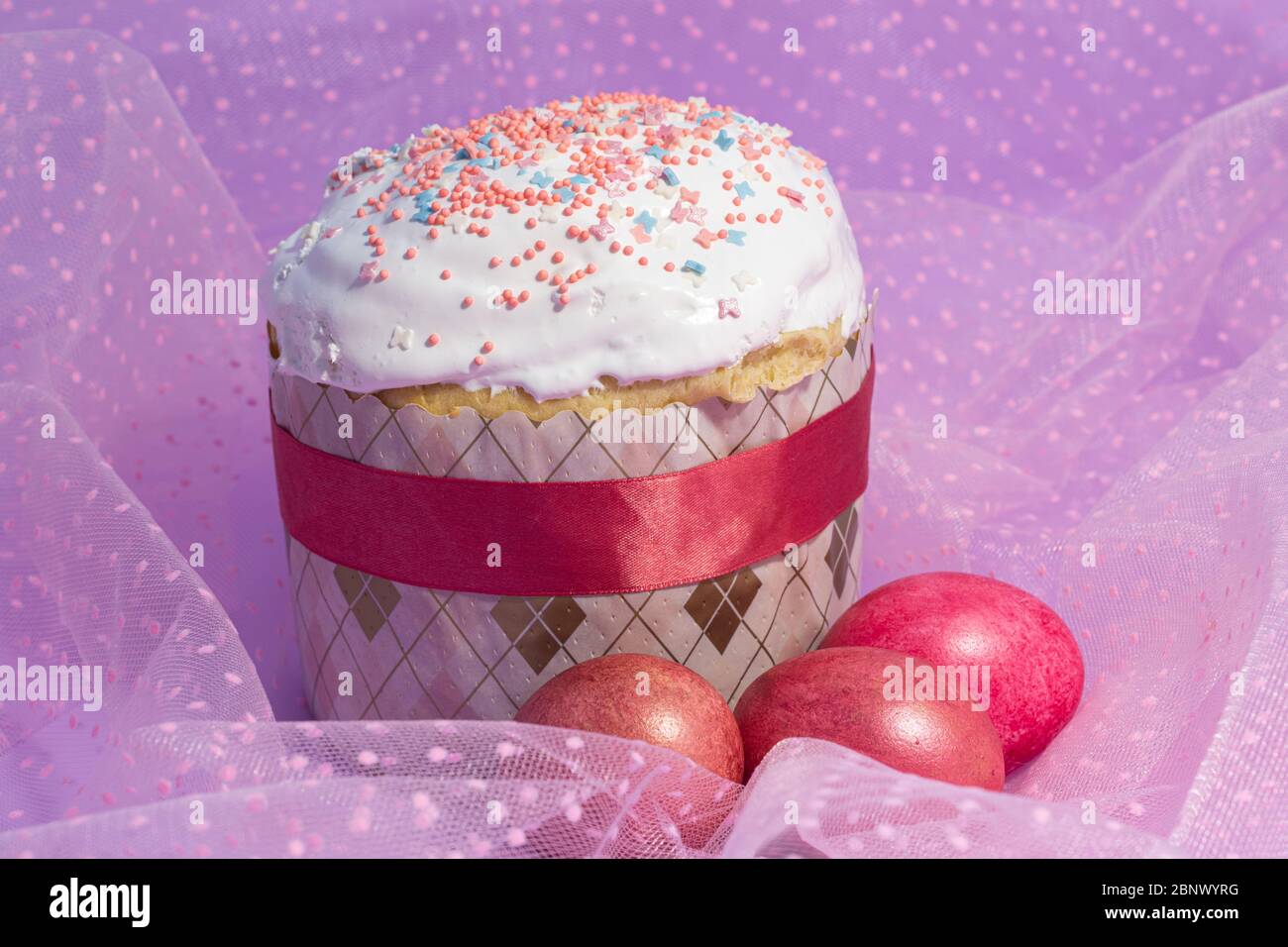 Easter cake decorated with pink decor and rose-colored eggs Stock Photo