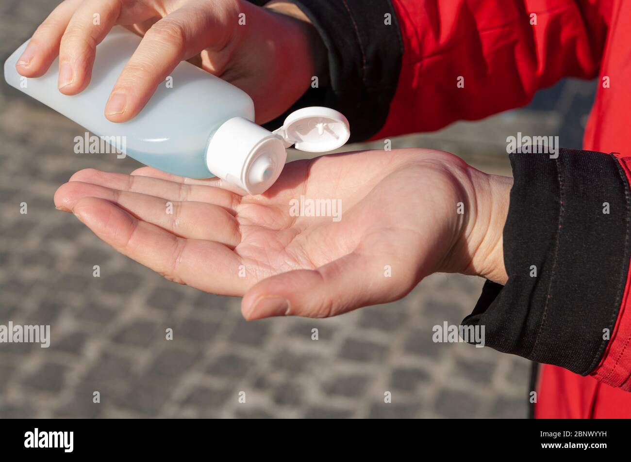Women's hands using wash hand sanitizer gel. Stock Photo
