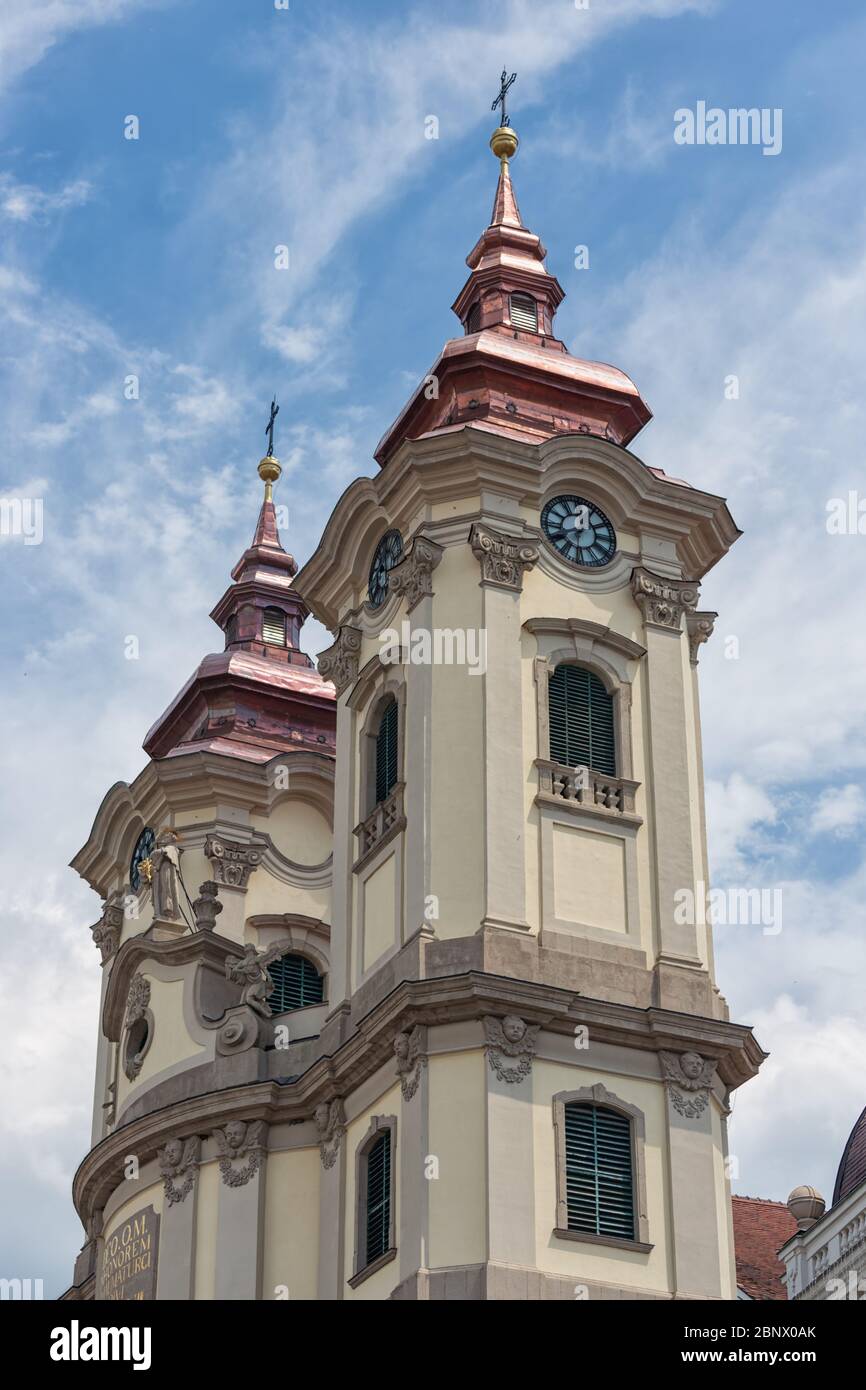 Clock towers Minorite church at Eger main square in Hungary Stock Photo