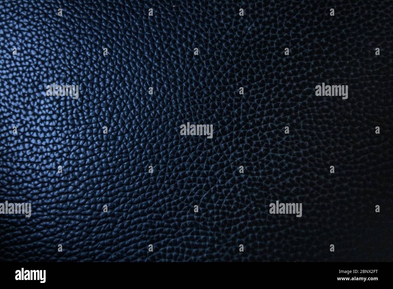 Beautiful blue leather texture one side highlights and one part shadows, background, 5K Stock Photo