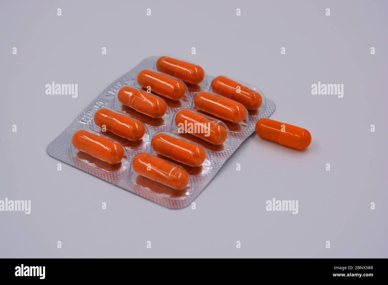 Medical preparations, medical pills in an orange capsule are located on
