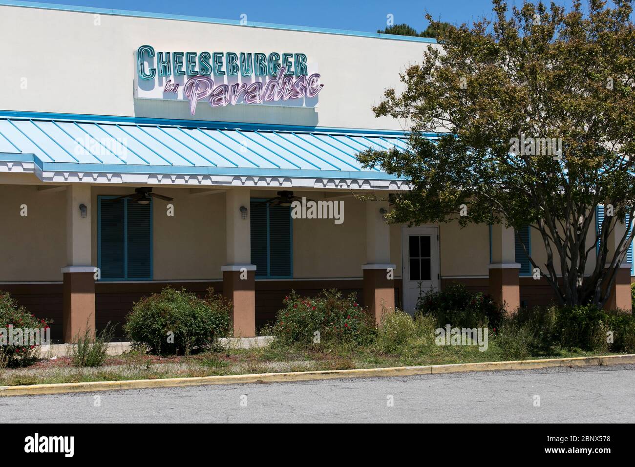 A logo sign outside of a closed and abandoned Cheeseburger in Paradise restaurant location in Virginia Beach, Virginia on May 2, 2020. Stock Photo