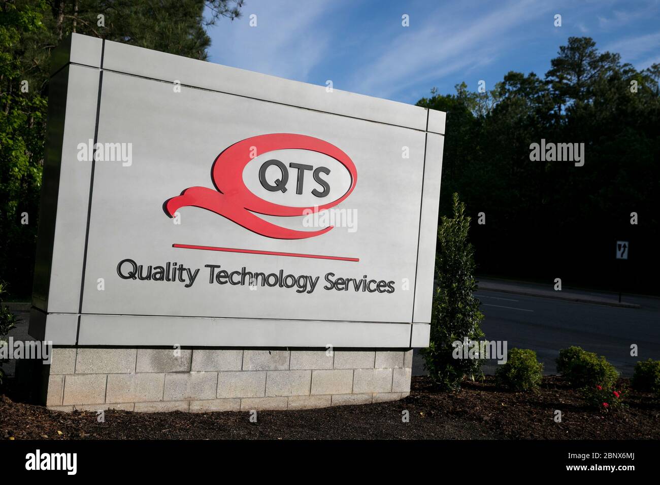 A logo sign outside of a Quality Technology Services (QTS) Data Center in Sandston, Virginia on May 2, 2020. Stock Photo