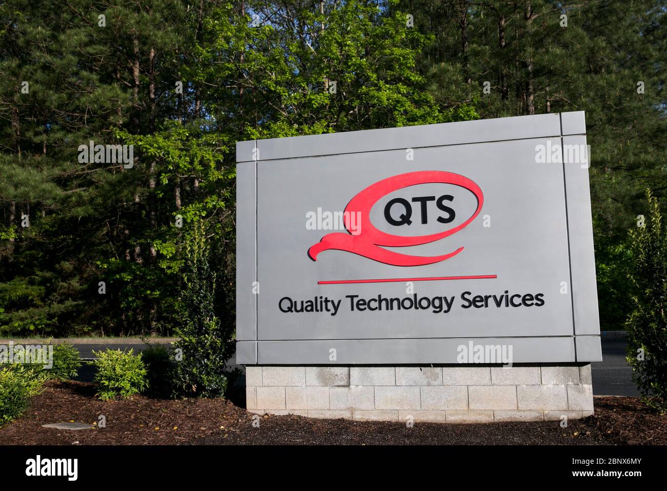 A logo sign outside of a Quality Technology Services (QTS) Data Center in Sandston, Virginia on May 2, 2020. Stock Photo