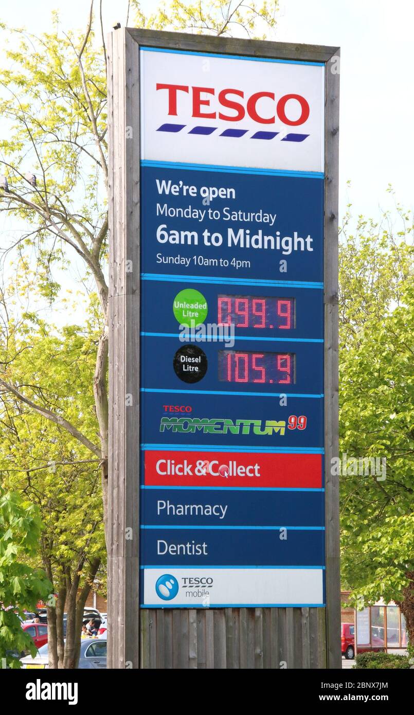 A Tesco petrol station sells unleaded petrol at 99.9p per litre, the first time since 2016 petrol has been sold below £1 per litre.The global oil market crash triggered by the coronavirus lockdown has seen the crude oil price plummet to a near 20-year low. Now, led by UK Supermarket chains, Unleaded petrol is now on sale throughout the country at below £1 per litre. Stock Photo