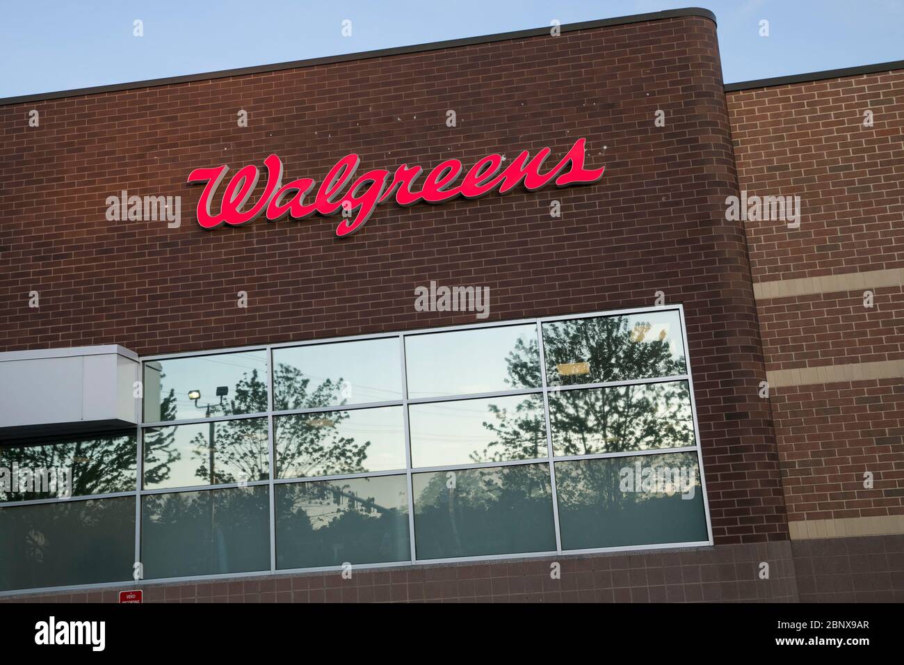 A logo sign outside of a Walgreens pharmacy location in Winchester