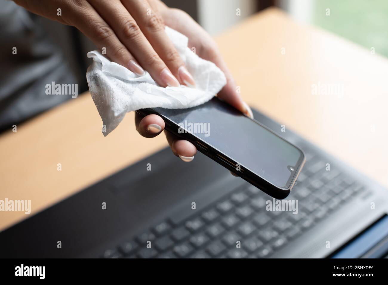 Work from home safe, cleaning and disinfecting smartphone and laptop