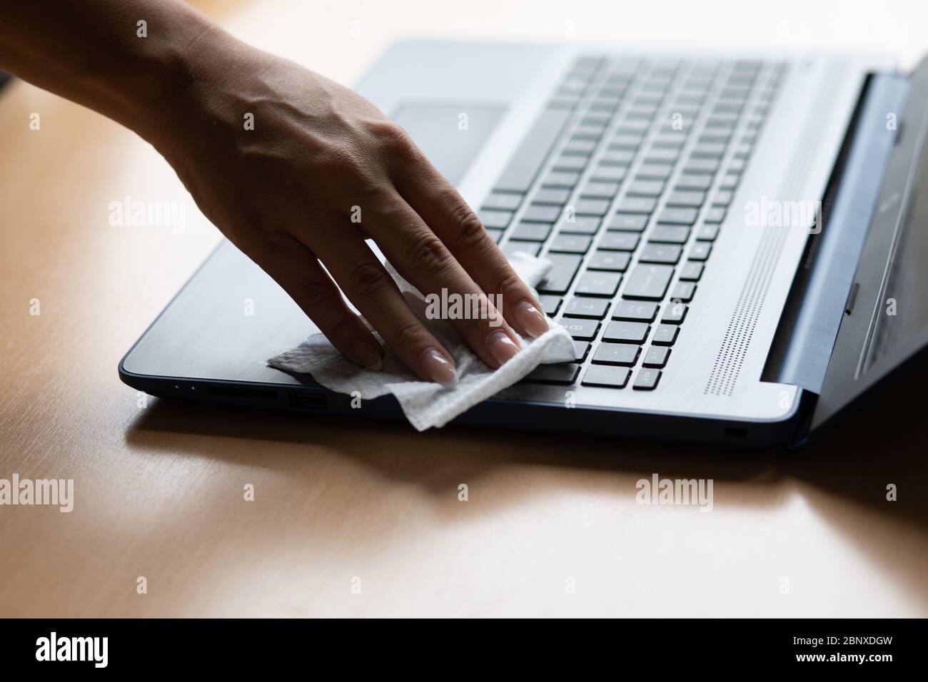 Work from home safe, cleaning and disinfecting laptop computer with wet