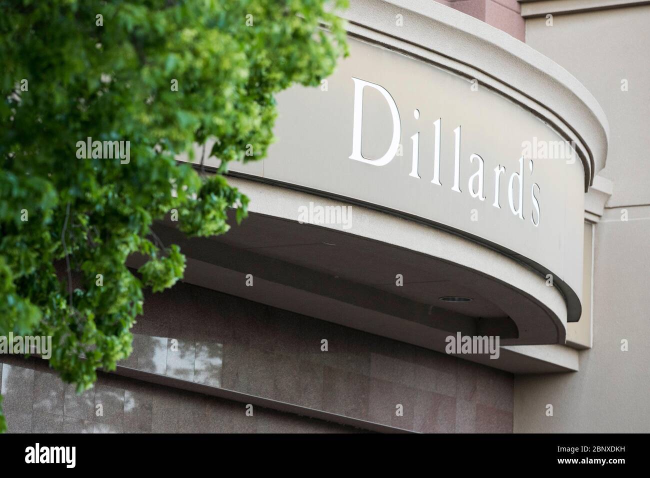 A logo sign outside of a Dillard's retail store location in Richmond