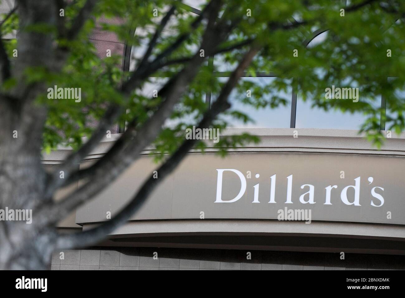 A logo sign outside of a Dillard's retail store location in Richmond