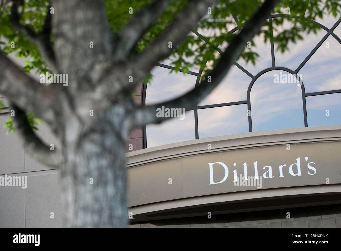 A logo sign outside of a Dillard's retail store location in Richmond