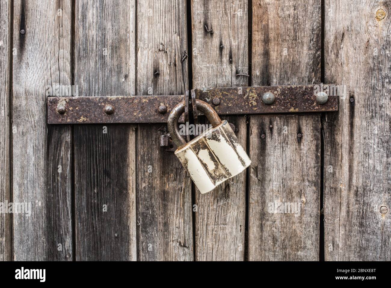 Old metal lock on old wooden door Stock Photo - Alamy