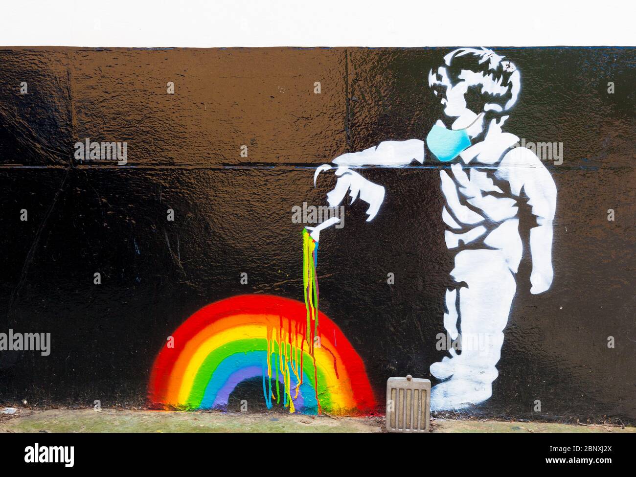 Rainbow boy, a 'Banksy' style stencil piece of street art on a wall. By Chris Shea, raising money for the NHS and key workers, Beckenham, London, UK. Stock Photo
