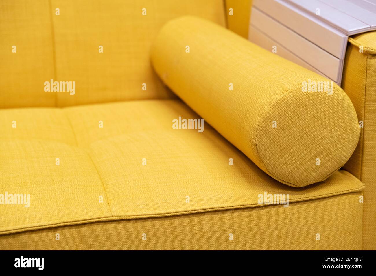 Yellow textile sofa with cushion. Close up Stock Photo Alamy