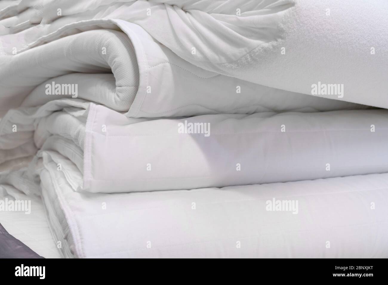 Stack of white mattresses in room. Close up Stock Photo
