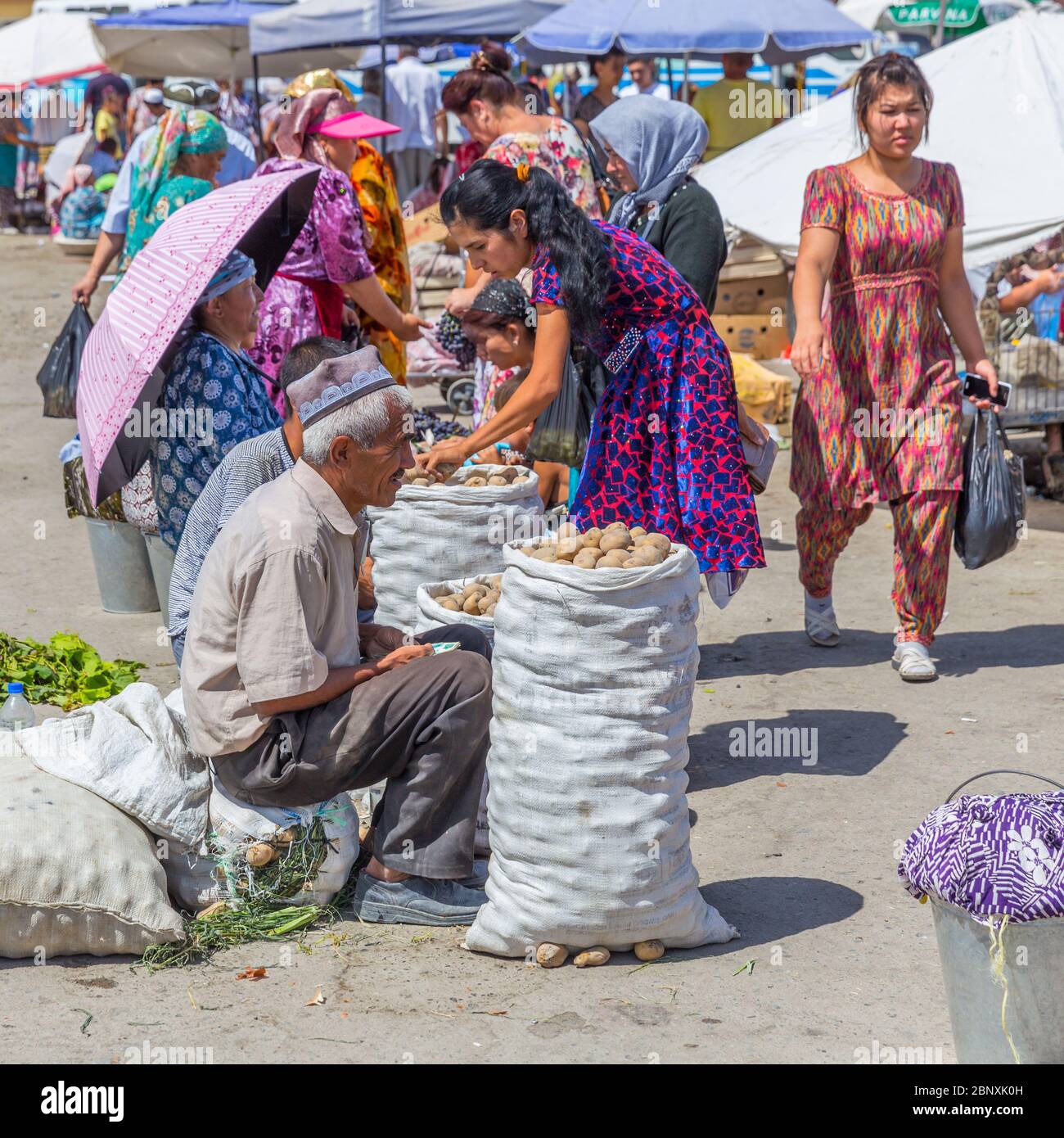 SAMARKAND, UZBEKISTAN - AUGUST 29, 2016: people make shopping at the fruit and vegetable market in Samarkand, Uzbekistan Stock Photo