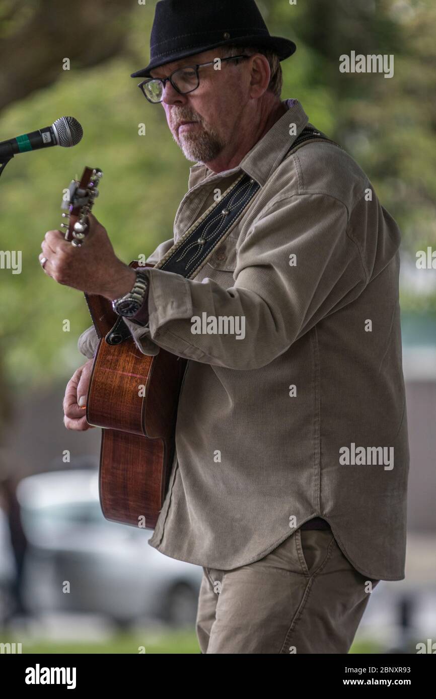 Folk Singer Performance Folk singer performing at oudoor concert. Singing and playing guitar ...