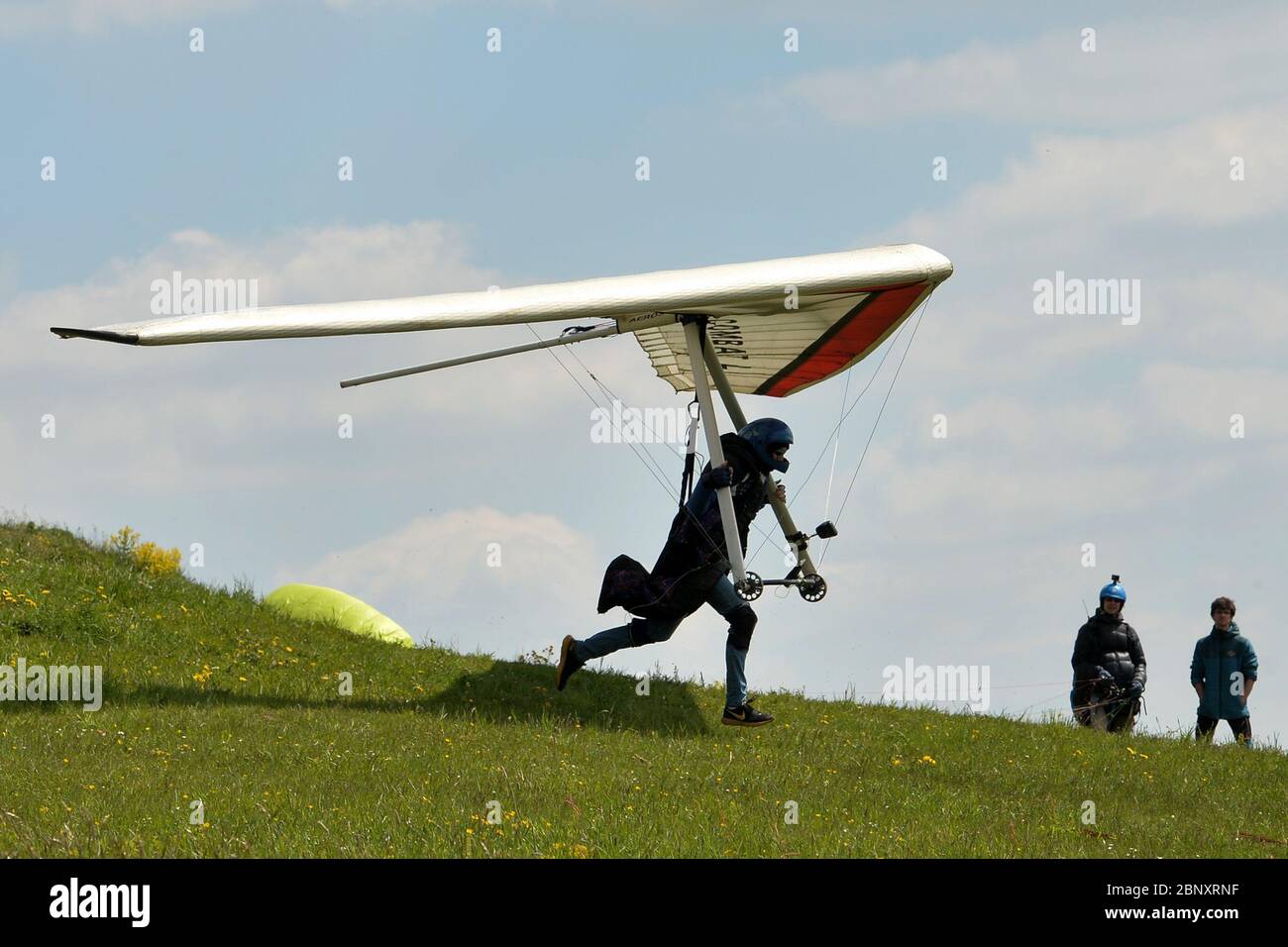 Kozakov, Czech Republic. 16th May, 2020. A Hang-glider steering an ultra light air craft has taken off from Kozakov (100 kilometers north from Prague) in the Czech Republic. Hang gliding is an air sport or recreational activity in which a pilot flies a light, non-motorised foot-launched heavier-than-air aircraft called a hang glider. Typically the pilot is in a harness suspended from the airframe, and controls the aircraft by shifting body weight in opposition to a control frame. Credit: Slavek Ruta/ZUMA Wire/Alamy Live News Stock Photo