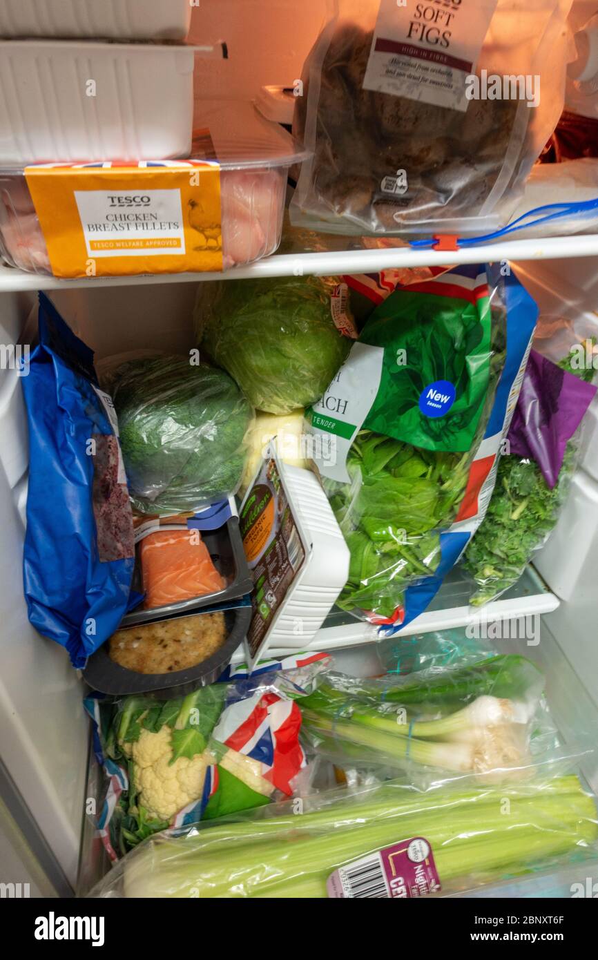 tightly packed small fridge with healthy food Stock Photo