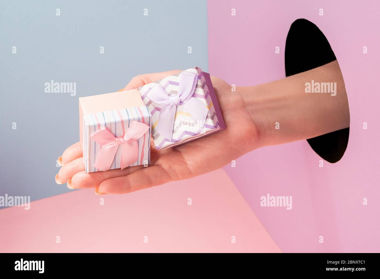 Close-up on hand showing two small gift boxes Stock Photo