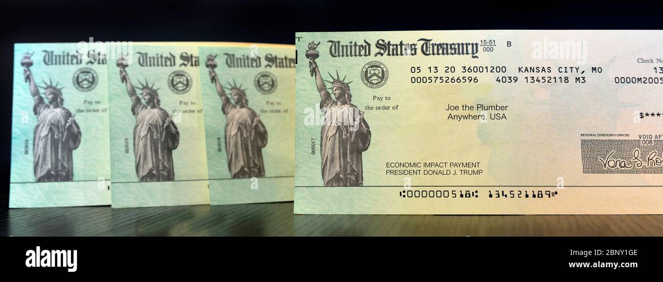 A standing upright row of United States Treasury Checks, payment for Economic impact from President Donald Trump, made payable to Joe the Plumber, iso Stock Photo