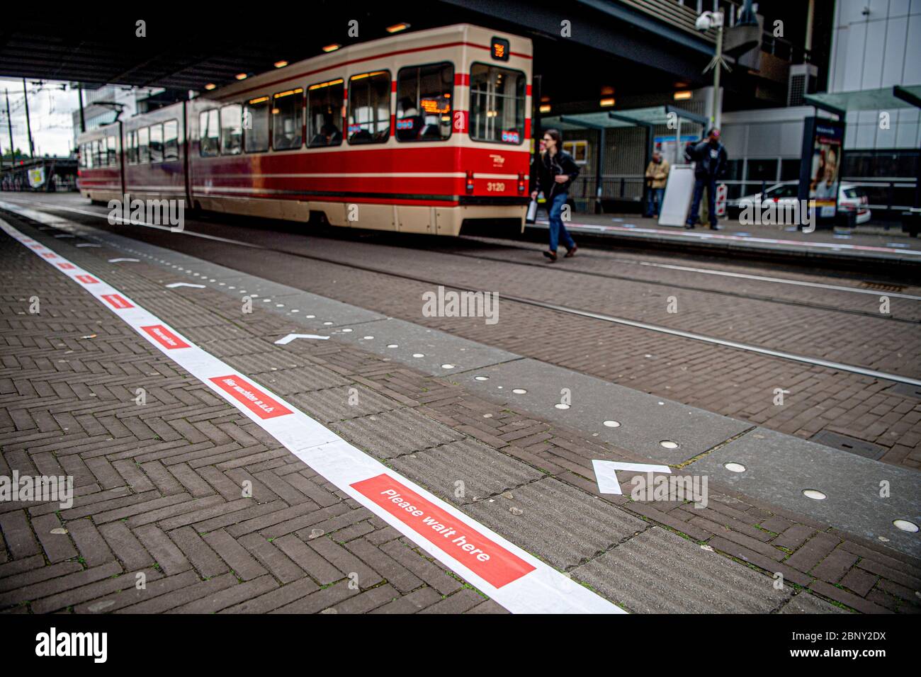Public transport company HTM social distance measure stickers and signs stuck at all stops in the centre of The Hague. The company wants to ensure that passengers obey the measure as public transport is getting busier as the lockdown is becoming more relaxed. Stock Photo