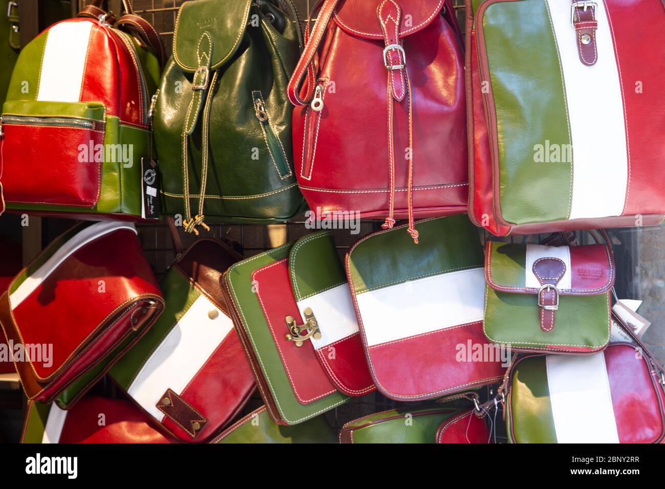 italian leather bags in red white and green for sale in a small store in San Gimignano, Tuscany,Italy Stock Photo