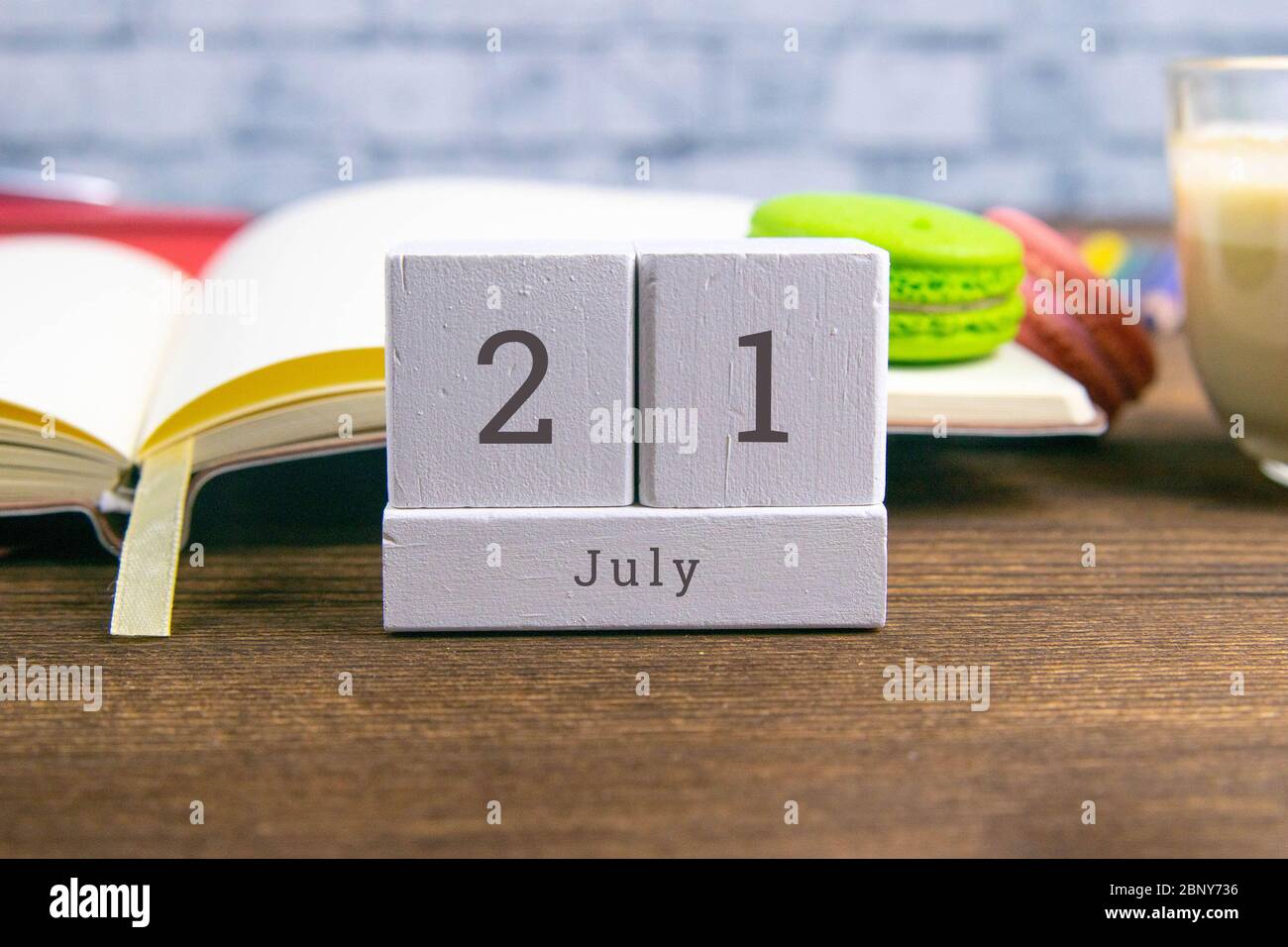 July 21 on a wooden calendar next to the alarm clock on the table. Summer day, empty space for text.Calendar date, birthday, or holiday Stock Photo - Alamy