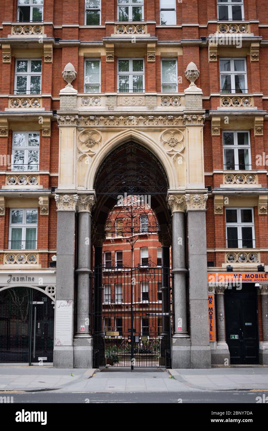 London, UK - 10 May 2020: Archway entrance into mansion apartment block Stock Photo