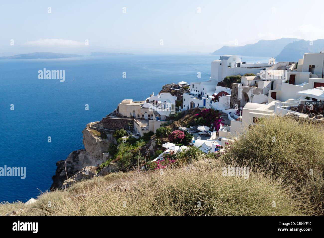 Traditional white washed Greek houses along the coastline with blue