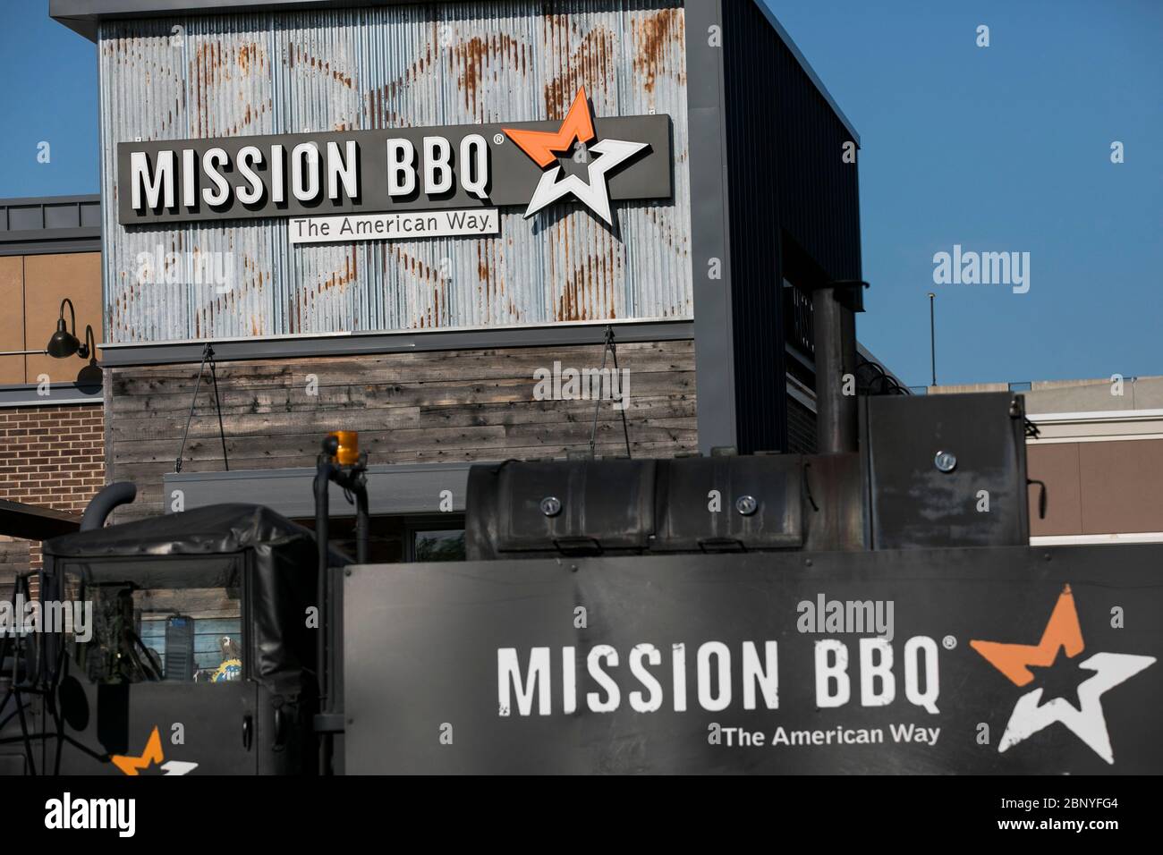 A logo sign outside of a Mission BBQ restaurant location in King of