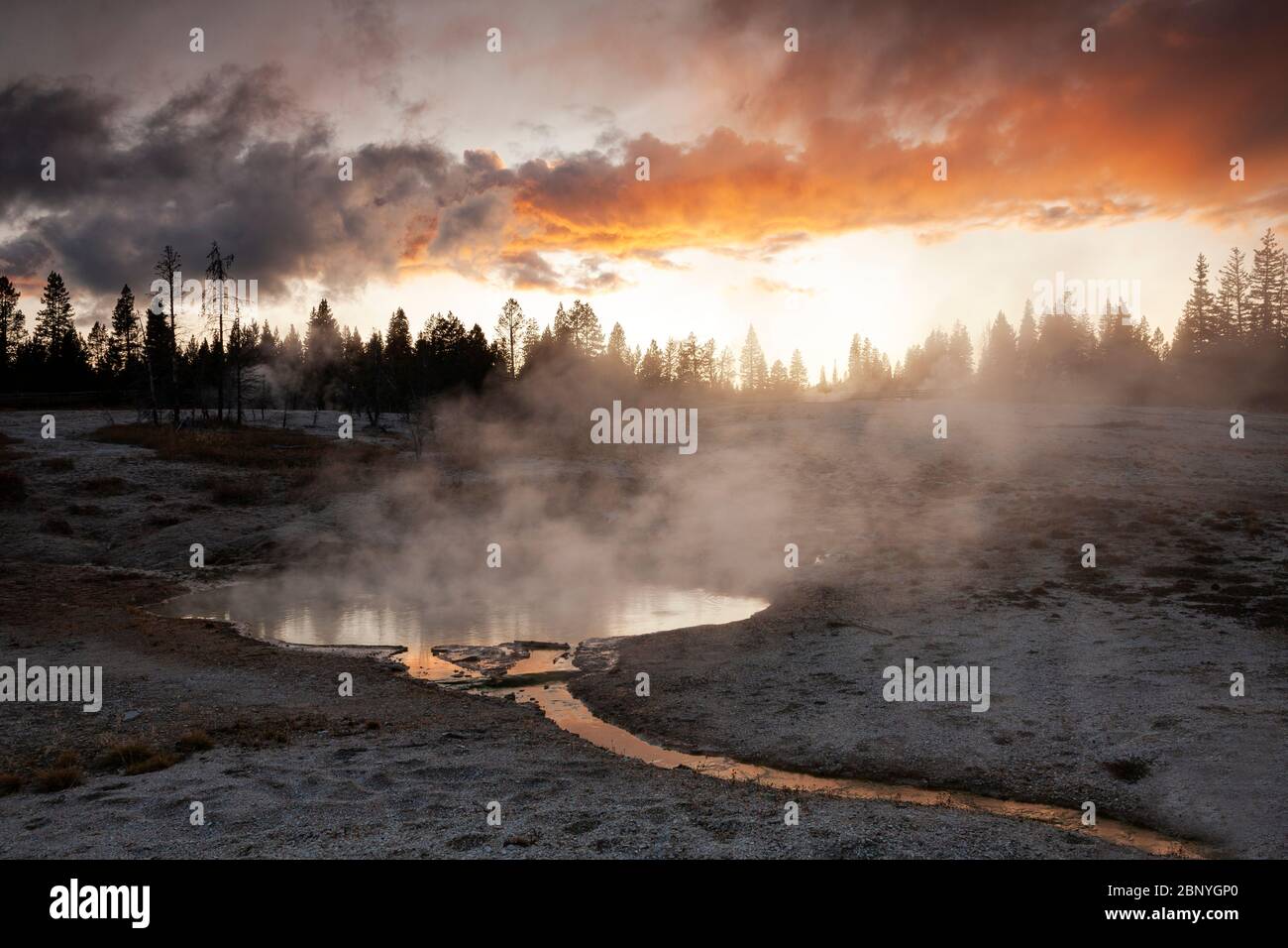 WY04388-00...WYOMING - Sunset and a steaming hotspring at West Thumb Geyser Basin in Yellowstone National Park. Stock Photo