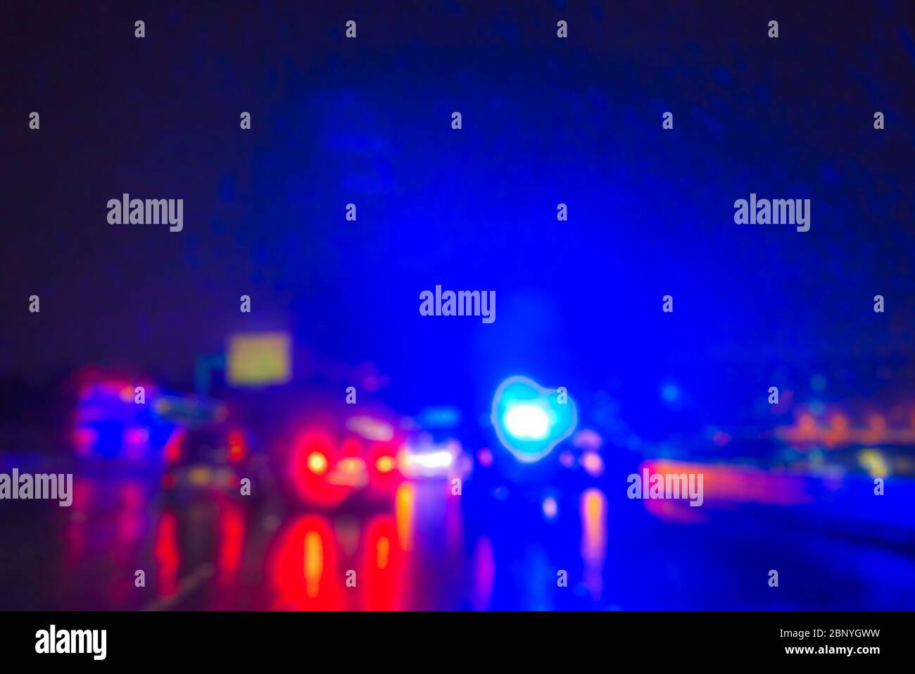 lighting of police car in the night during accident on the road when raining. Stock Photo